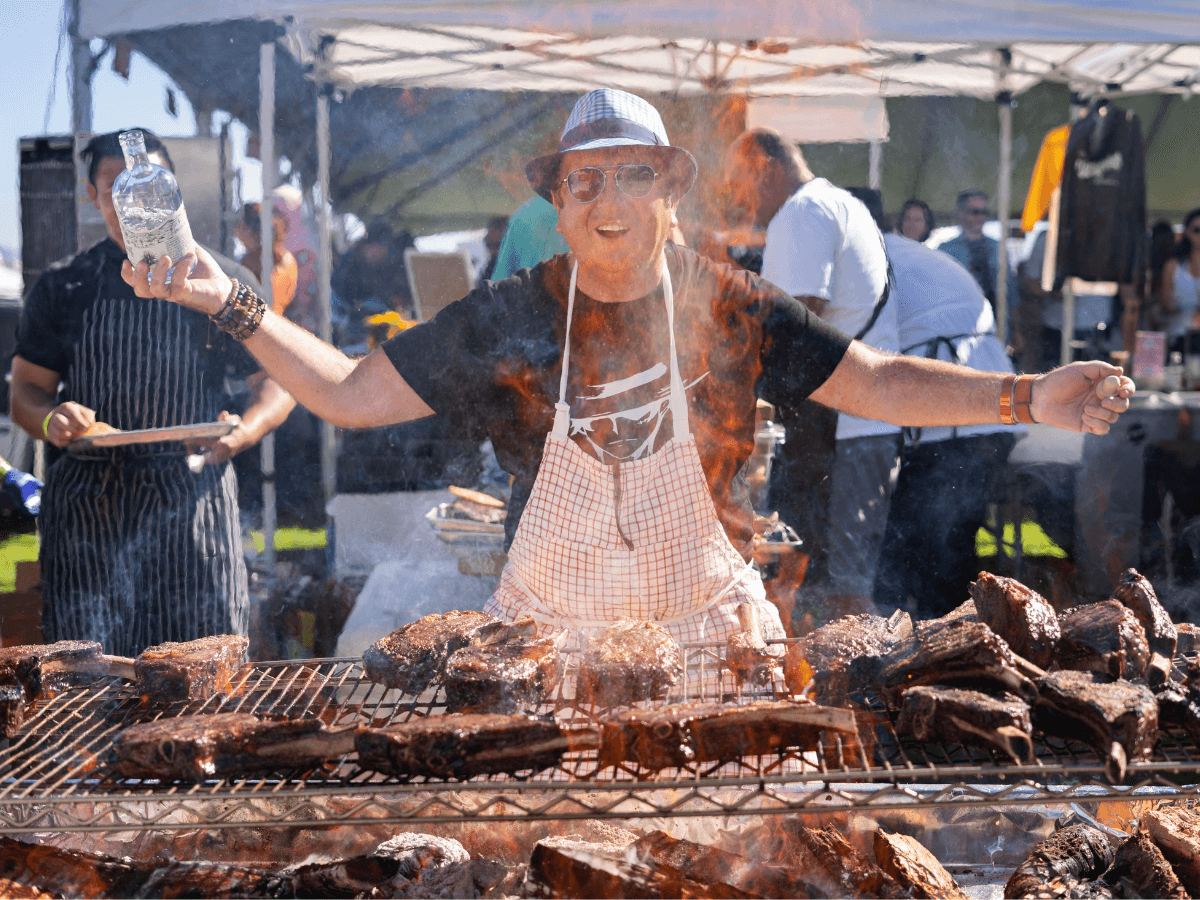 A chef working a live-fire grill