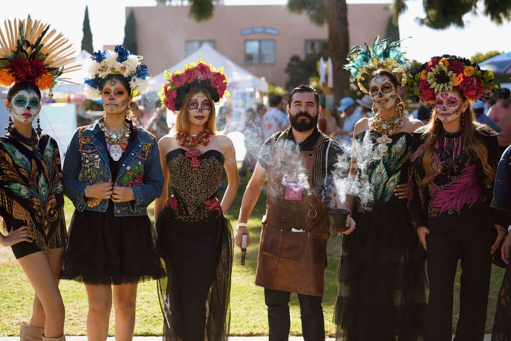 Performers in Día de Muertos dress