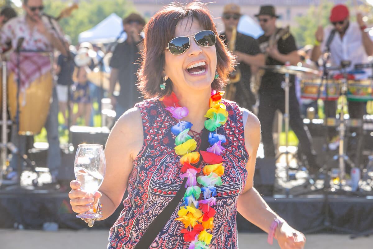 A guest laughing with a glass in hand