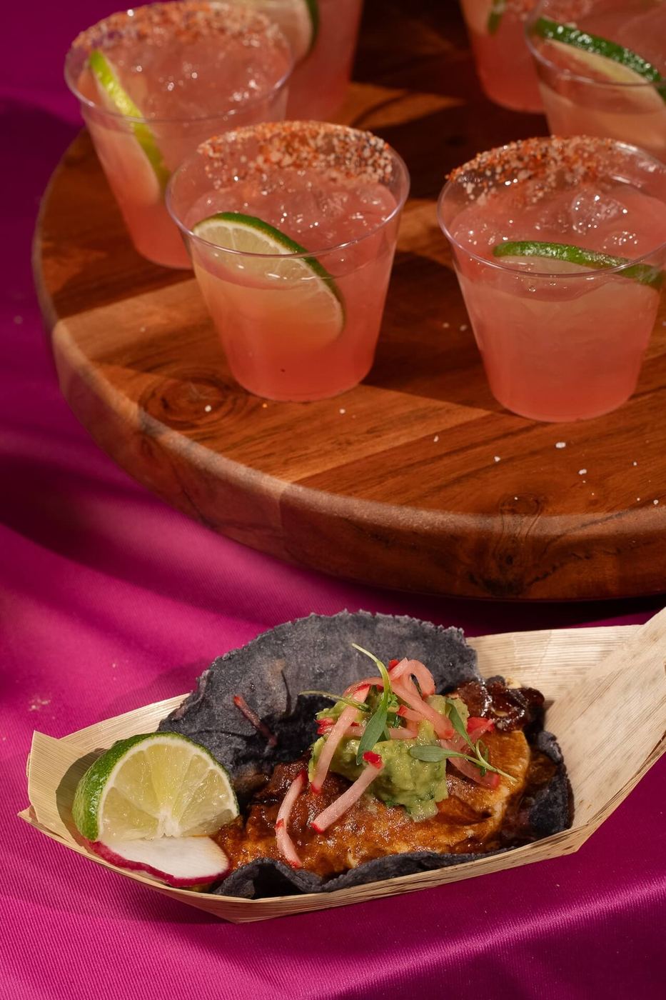 Margaritas and a taco on a serving board