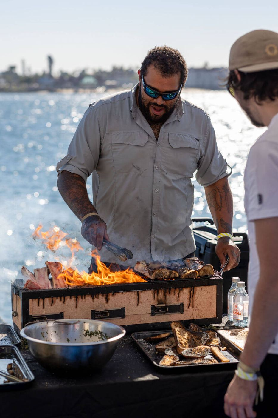 A chef grilling beside the bay