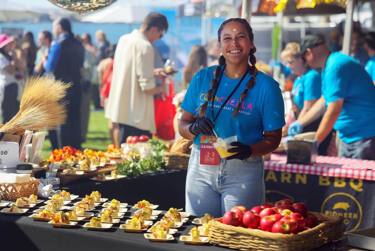 A chef serving plates at her station