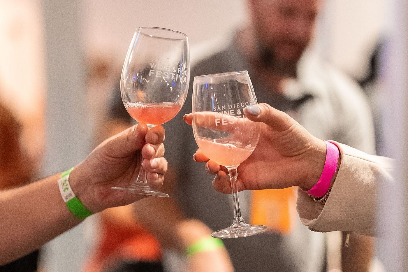 Two glasses meeting in a toast