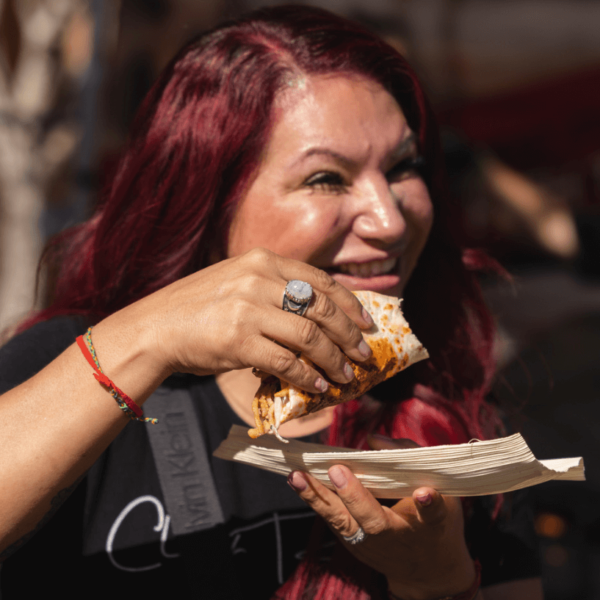 Chef Rosie O'Connor tasting a taco at San Diego Bay Wine & Food Festival Grand Fiesta