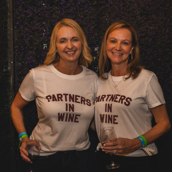 Attendees wearing matching 'Partners in Wine' shirts at San Diego Bay Wine & Food Festival Grand Decant