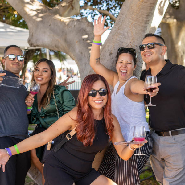 Attendees posing for a photo at the San Diego Bay Wine & Food Festival Grand Tasting