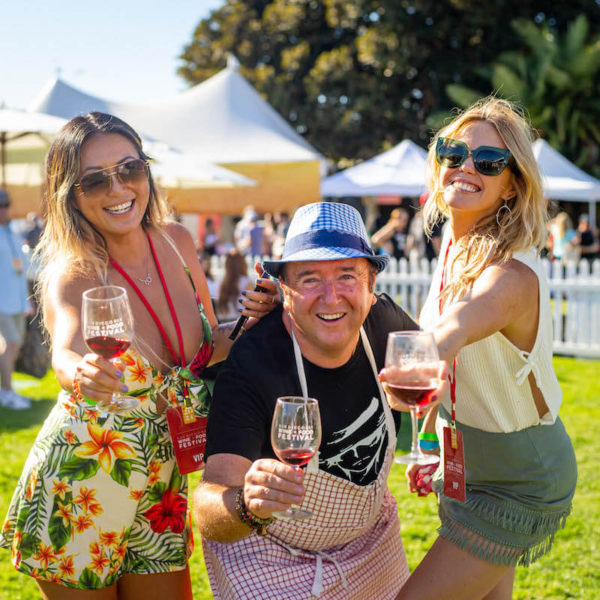 Chef Bernard Guillas and friends holding wine glasses at the San Diego Bay Wine & Food Festival Grand Tasting