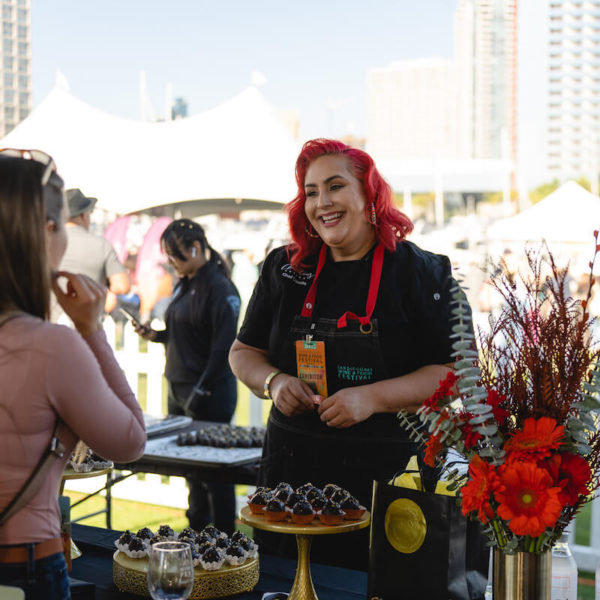 Chef Claudia Sandoval interacts with attendees at San Diego Bay Wine & Food Festival Grand Tasting VIP Experience