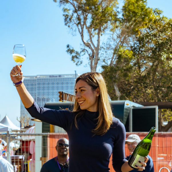 Lorena Woods leading a champagne sabre demonstration and toast at the San Diego Bay Wine & Food Festival Grand Tasting